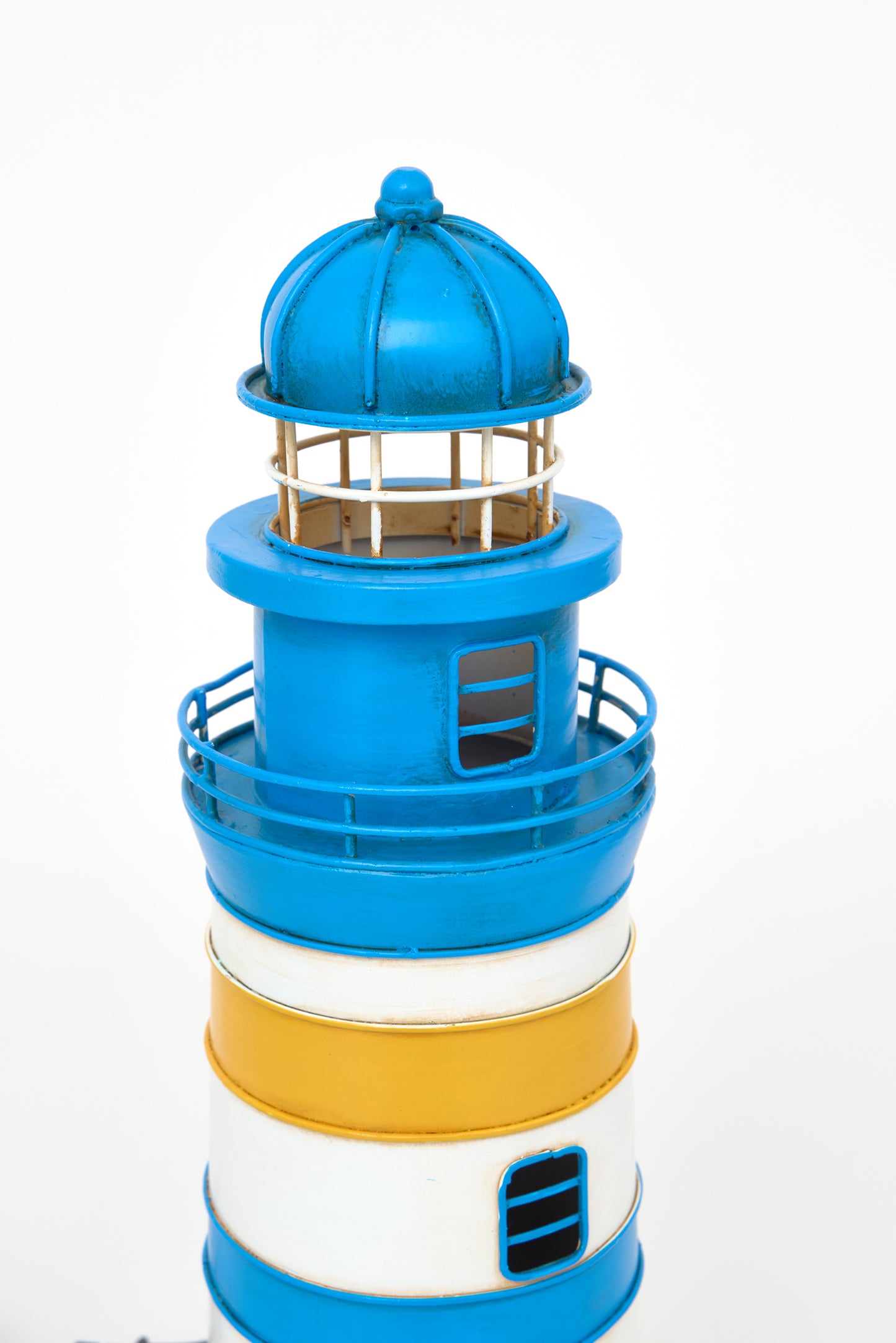 Blue and yellow metal lighthouse lamp
