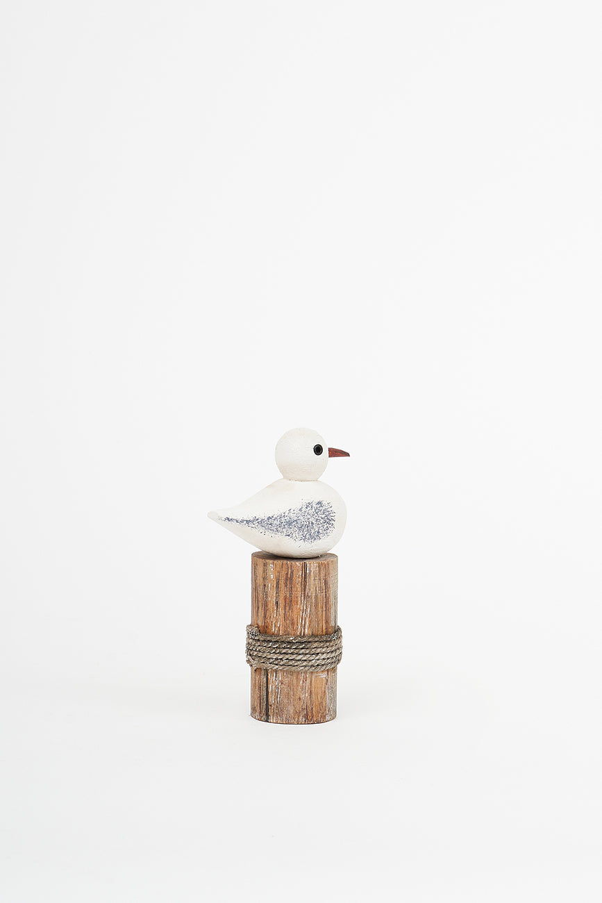 Wooden bird on a log