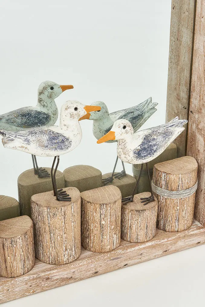 Espejo rectangular con pájaros sobre troncos