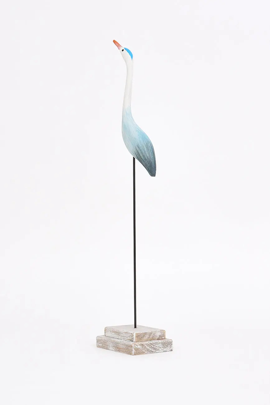 Pájaro con base hecha de madera en tonos azules y turquesa