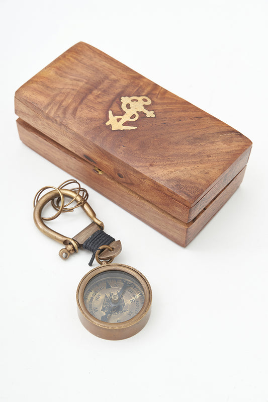 Brass compass keychain in a wooden box