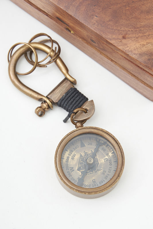 Brass compass keychain in a wooden box