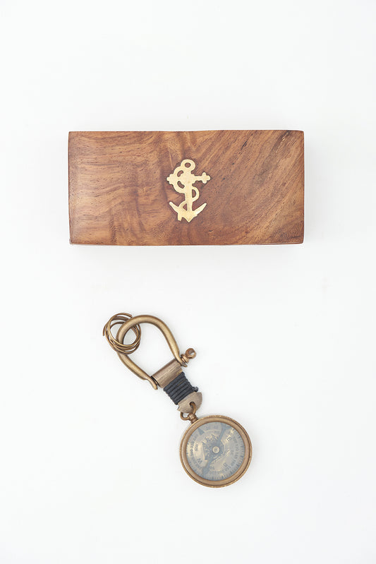 Brass compass keychain in a wooden box