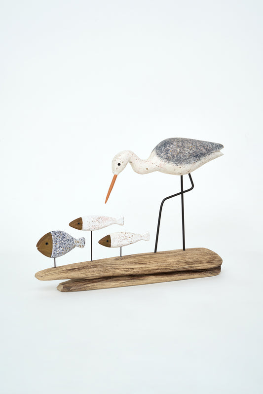 Decorative wooden bird figurine with fish