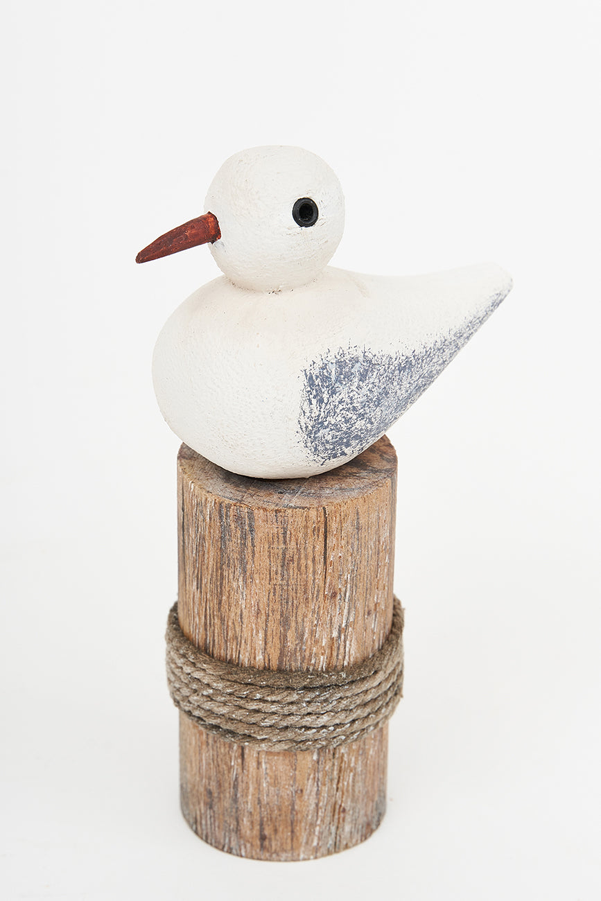 Wooden bird on a log