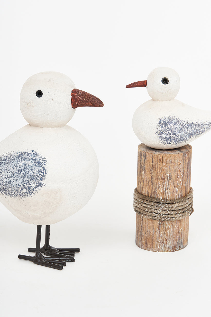 Wooden bird on a log