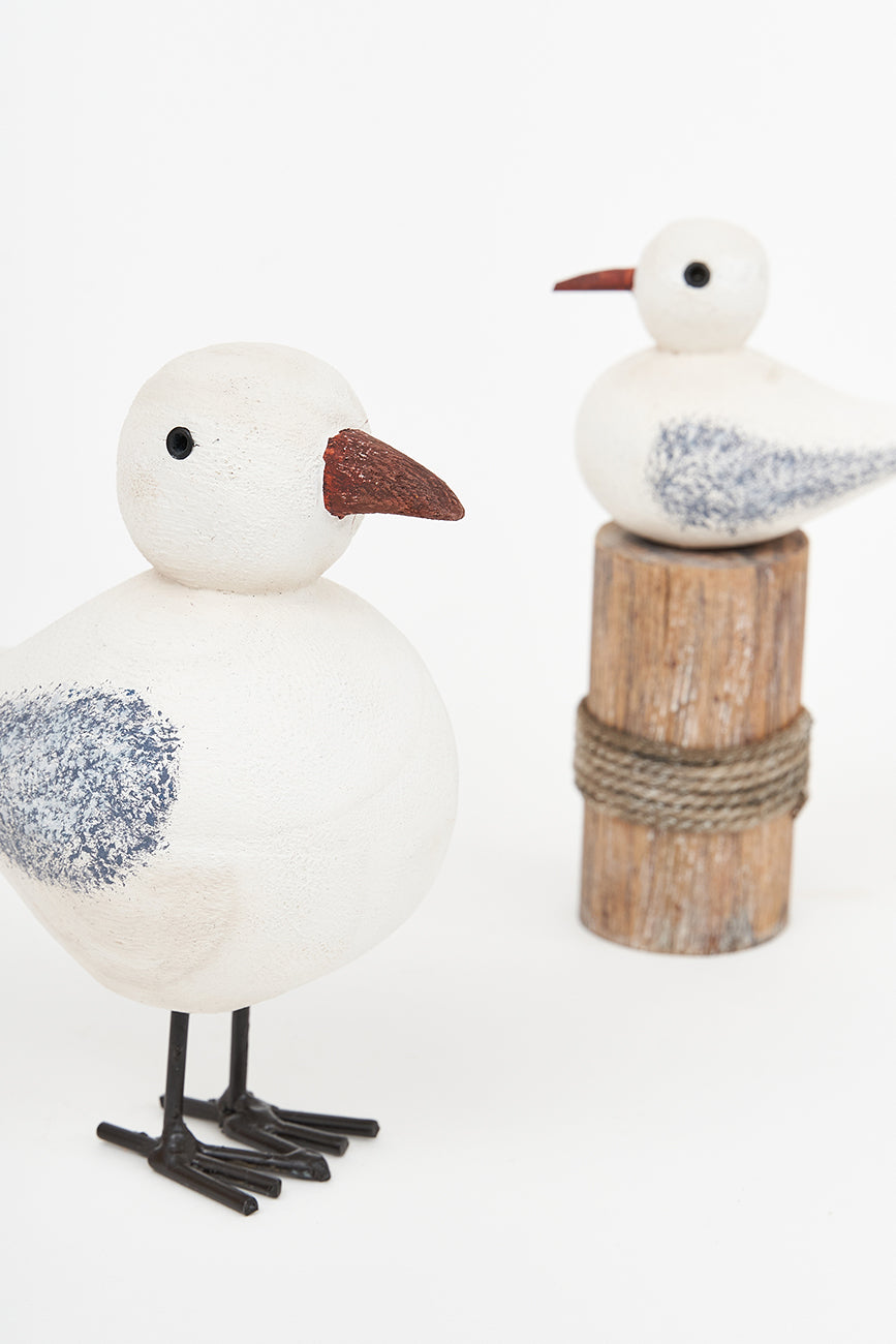 Wooden bird on a log