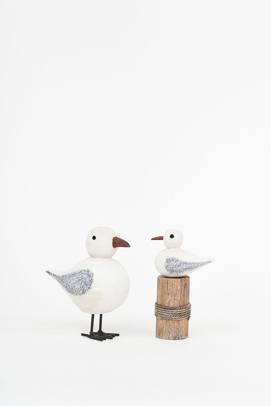 Wooden bird on a log
