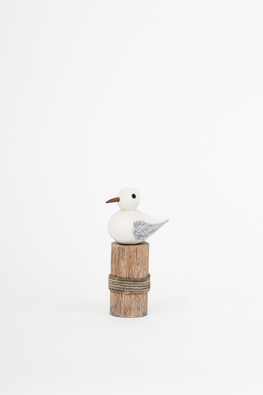 Wooden bird on a log