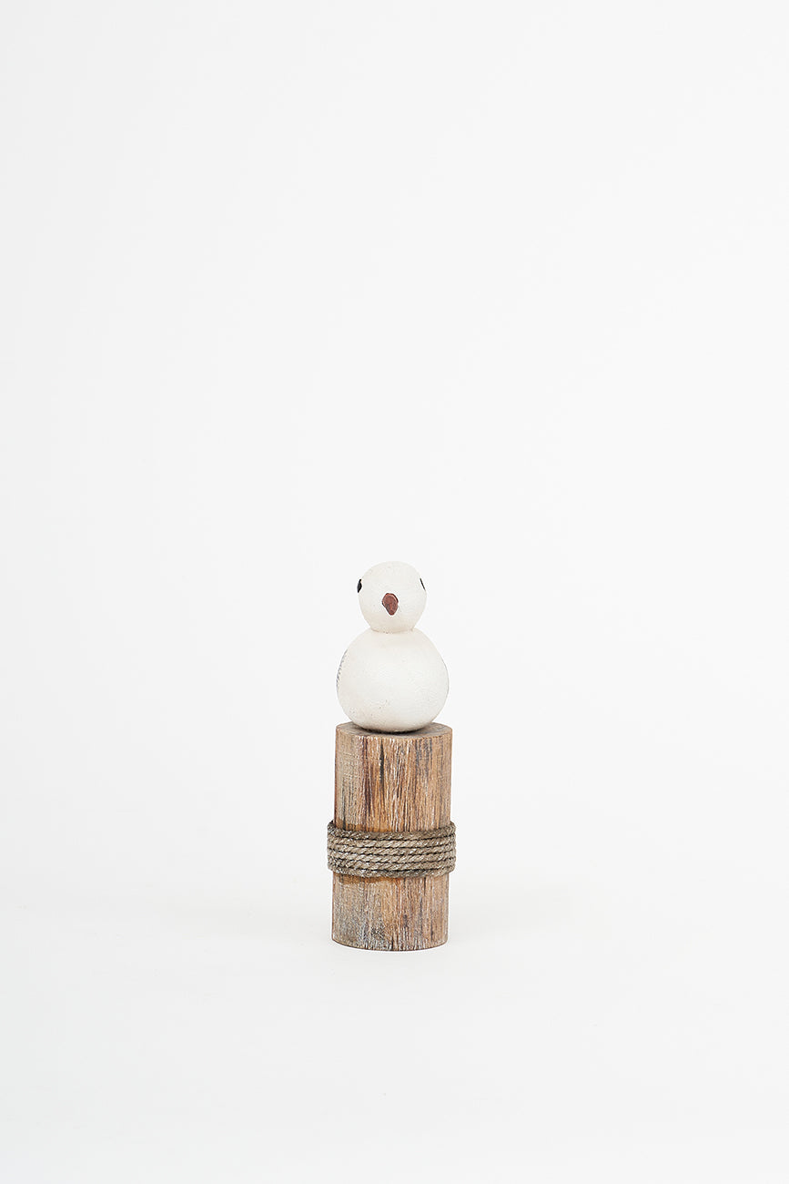Wooden bird on a log
