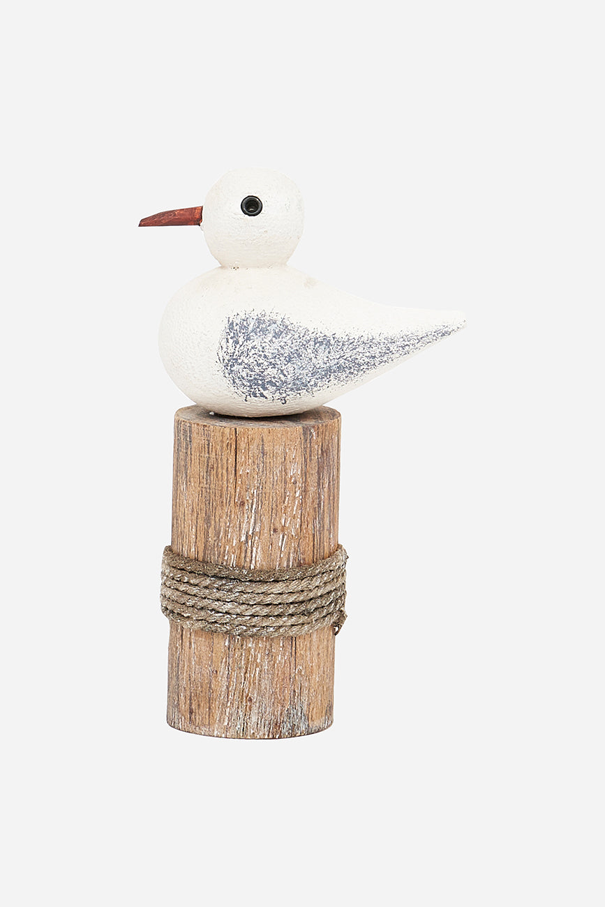 Wooden bird on a log