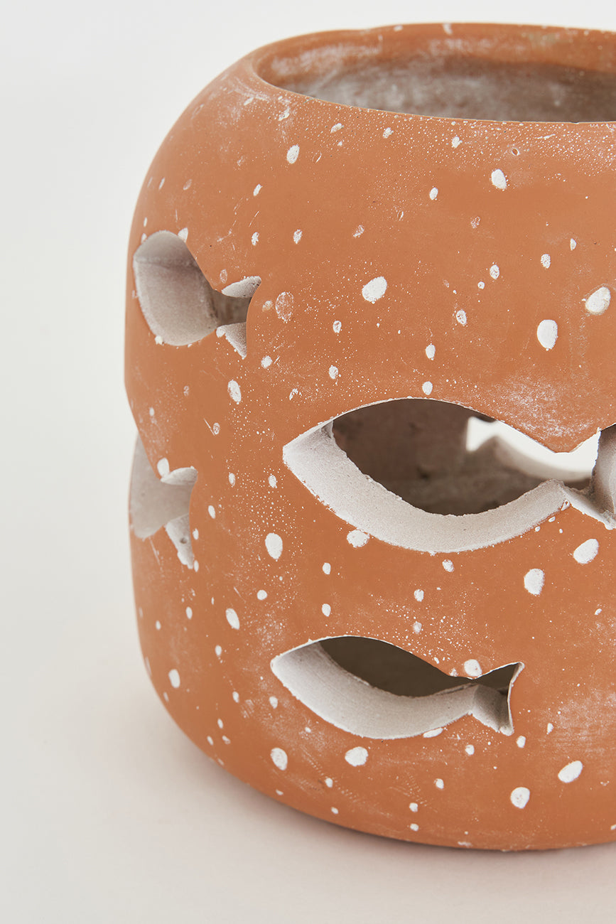 Large cement candle holder with perforated fish