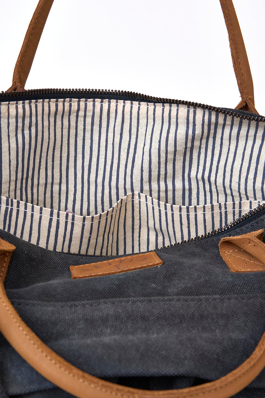 Green canvas bag with striped lining