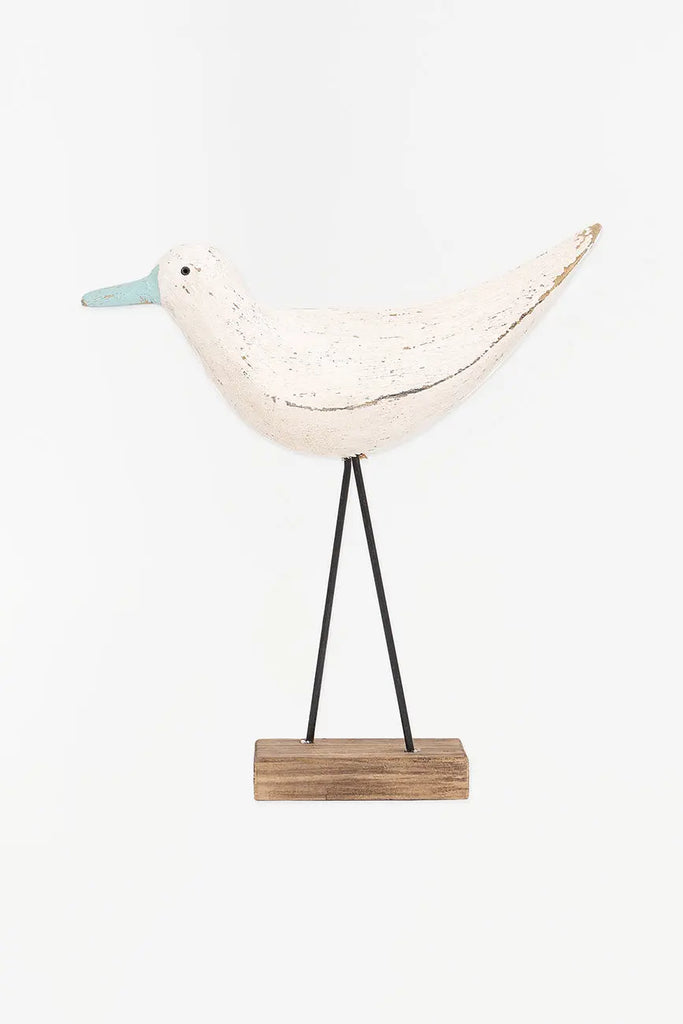 Figura de pájaro blanco y pico en contraste turquesa