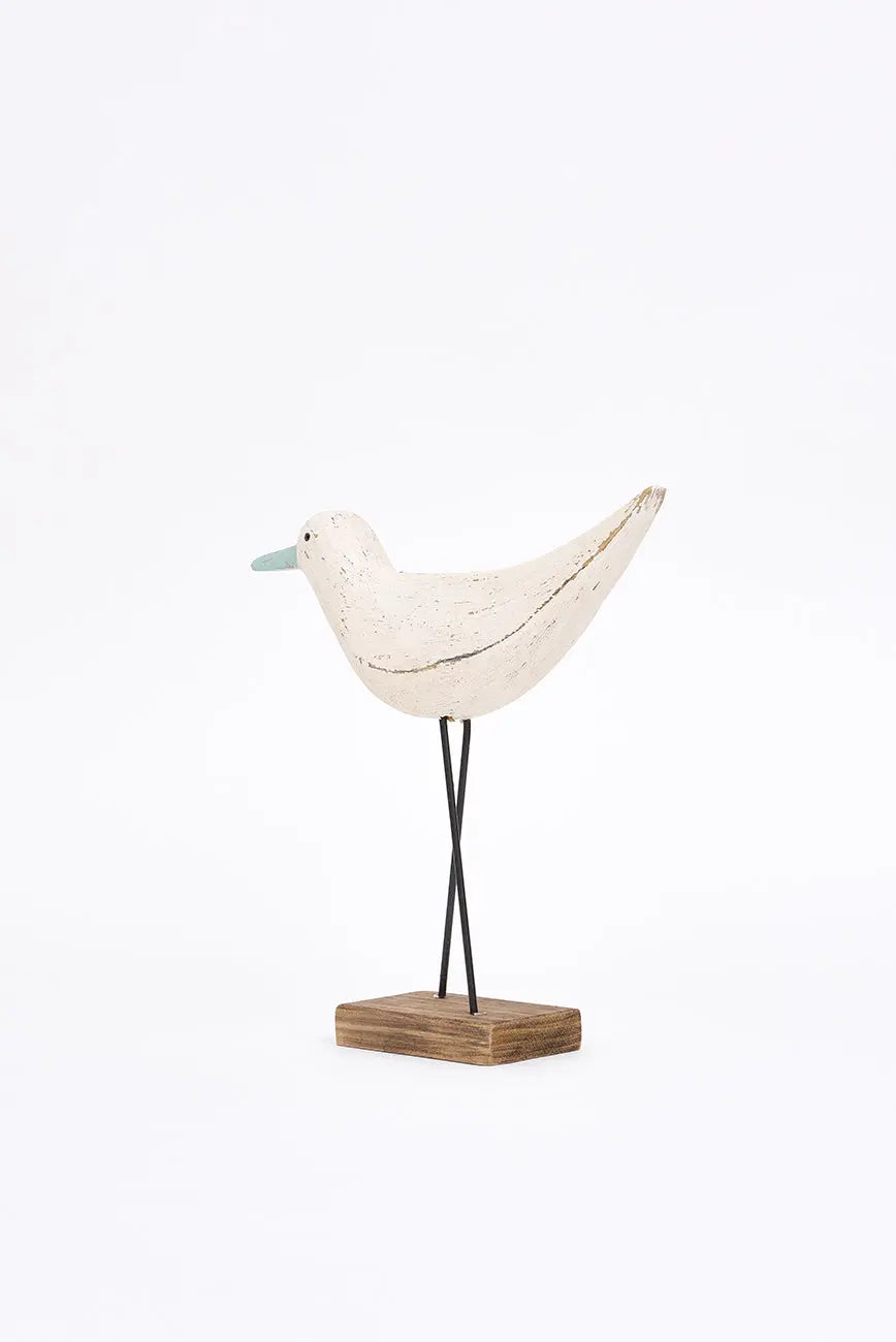Figura de pájaro blanco y pico en contraste turquesa