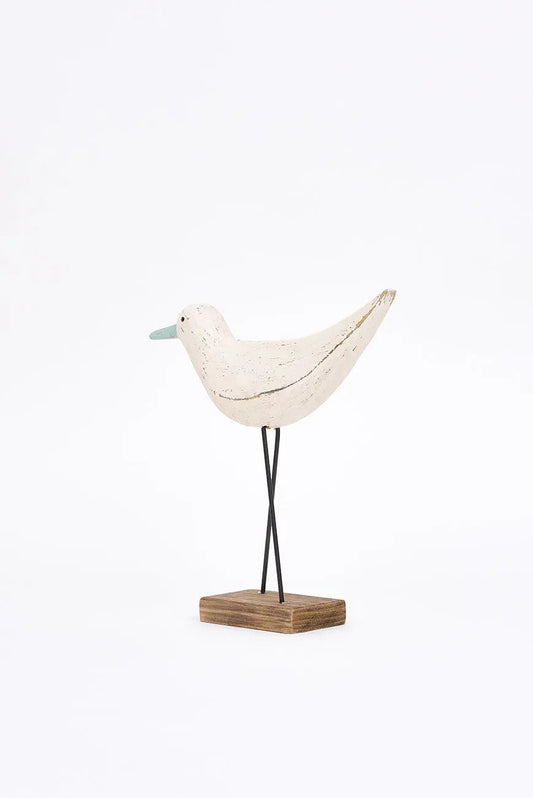 Figura de pájaro blanco y pico en contraste turquesa