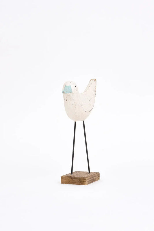 Figura de pájaro blanco y pico en contraste turquesa
