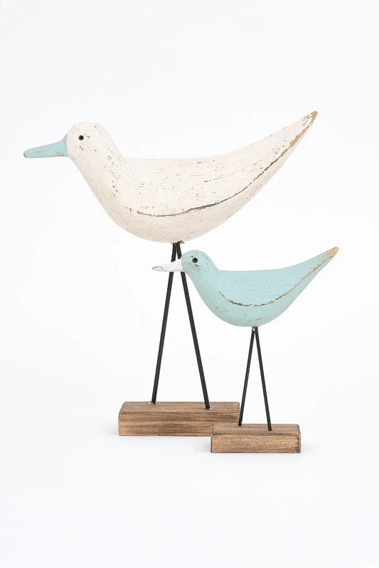 Figura de pájaro blanco y pico en contraste turquesa