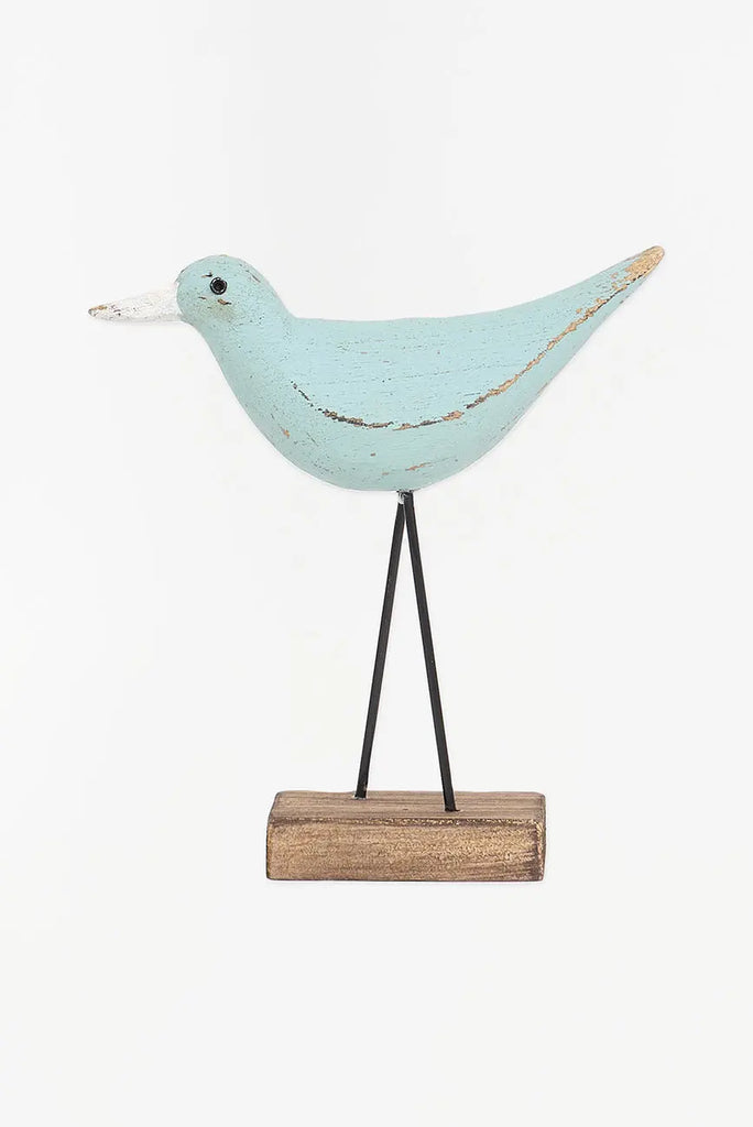 figura de pájaro turquesa y pico en contraste blanco