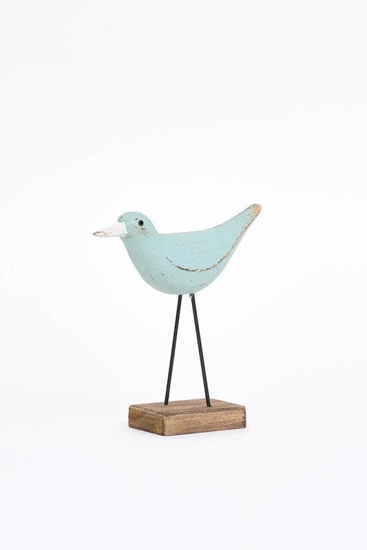 figura de pájaro turquesa y pico en contraste blanco