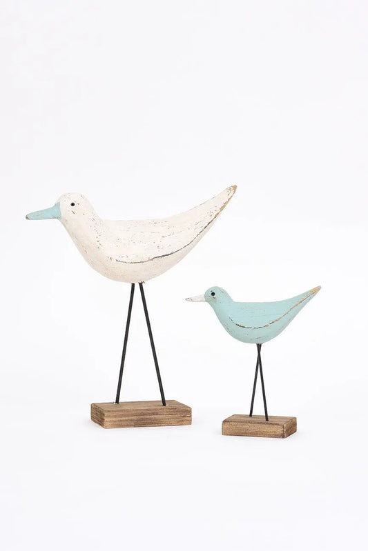 figura de pájaro turquesa y pico en contraste blanco