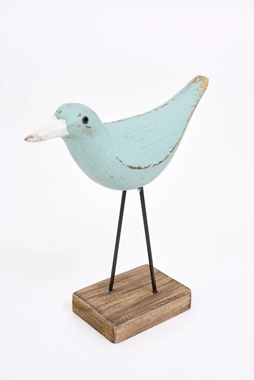 figura de pájaro turquesa y pico en contraste blanco