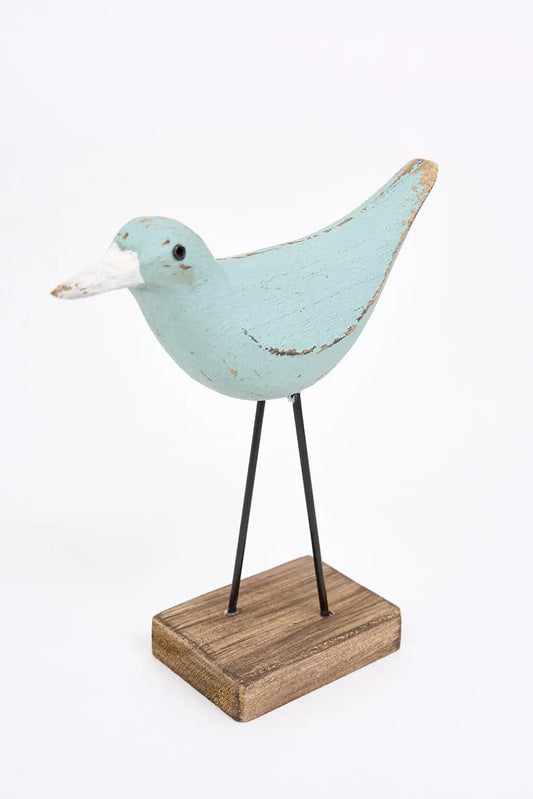 figura de pájaro turquesa y pico en contraste blanco