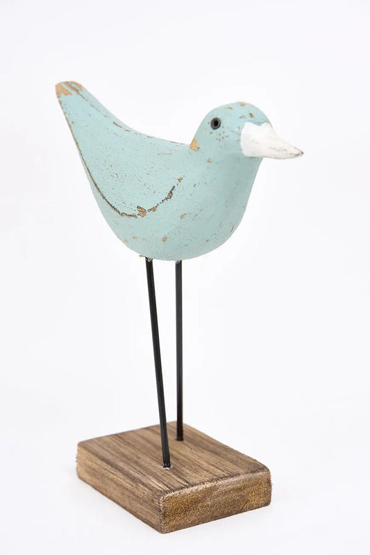 figura de pájaro turquesa y pico en contraste blanco