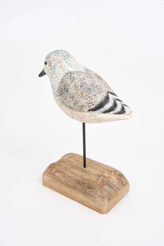 Pájaro de madera en tonos blancos, negros y grises