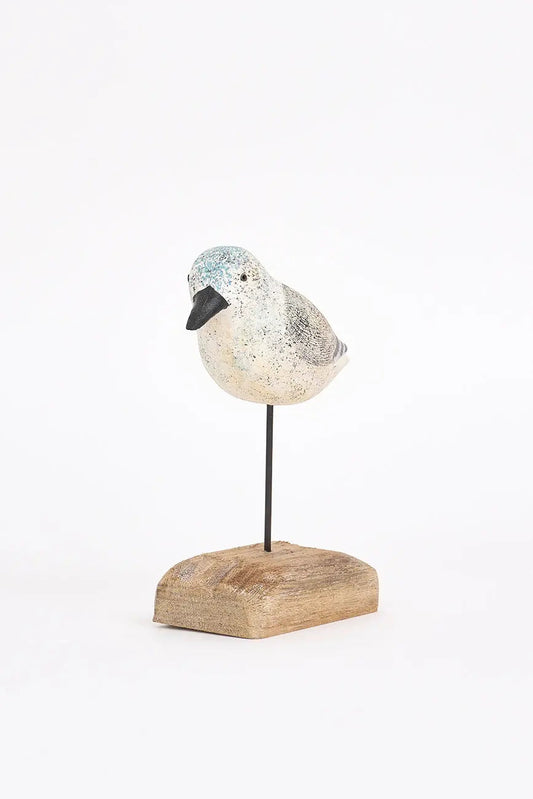 Pájaro de madera en tonos blancos, negros y grises