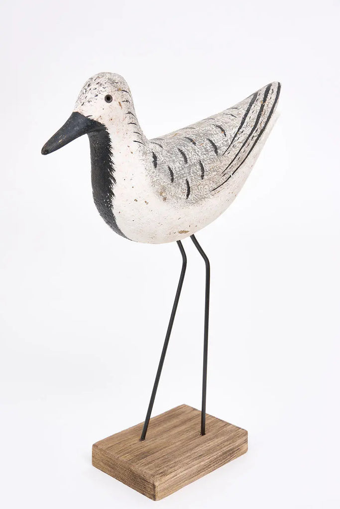 Pájaro de madera en tonos blancos, negros y grises
