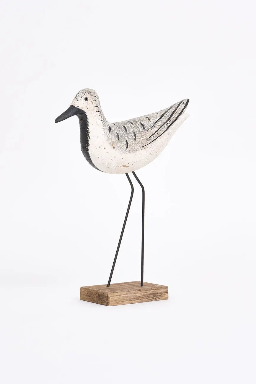 Pájaro de madera en tonos blancos, negros y grises