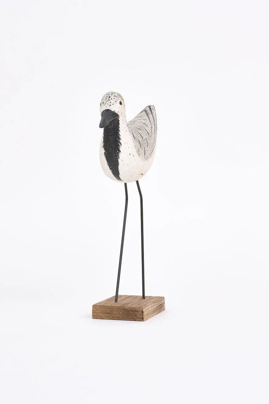 Pájaro de madera en tonos blancos, negros y grises