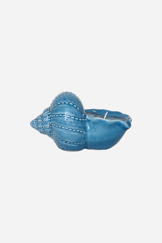 Decorative candle in a blue seashell