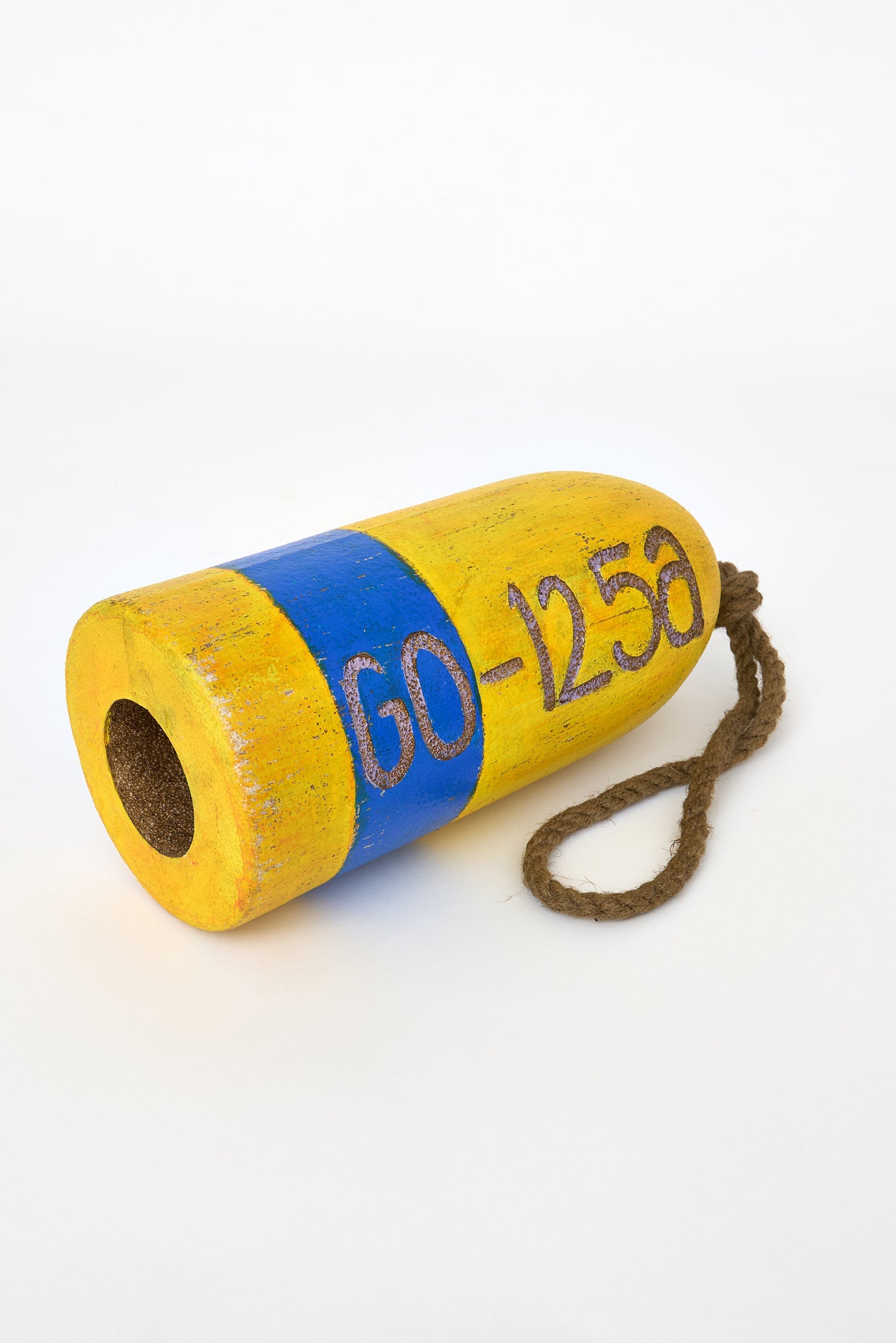 Yellow and blue decorative buoy with rope