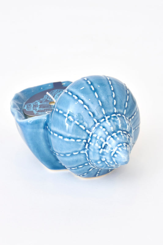 Decorative candle in a blue seashell