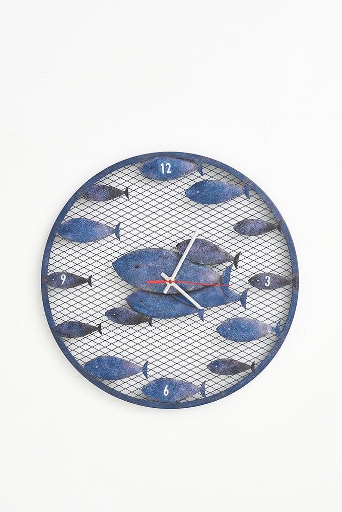 Reloj de metal con banco de peces